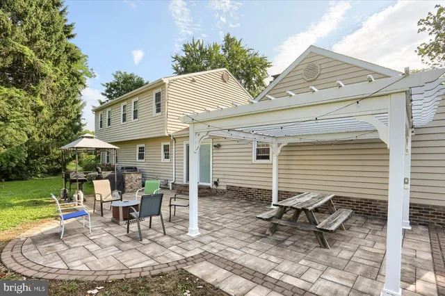 a view of a house with backyard porch and sitting area