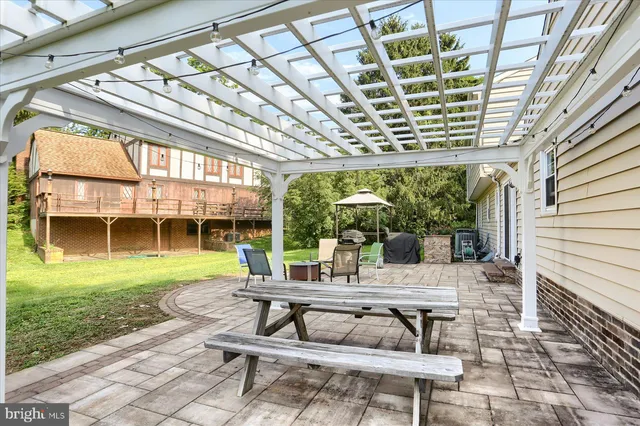 a view of a patio with table and chairs and potted plants