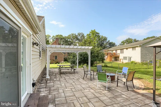 a view of a porch with chairs and backyard