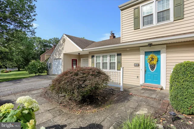 a view of a house with a yard and a garden
