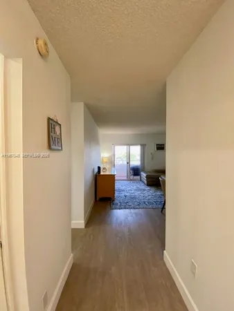 a living room with furniture wooden floor and a table