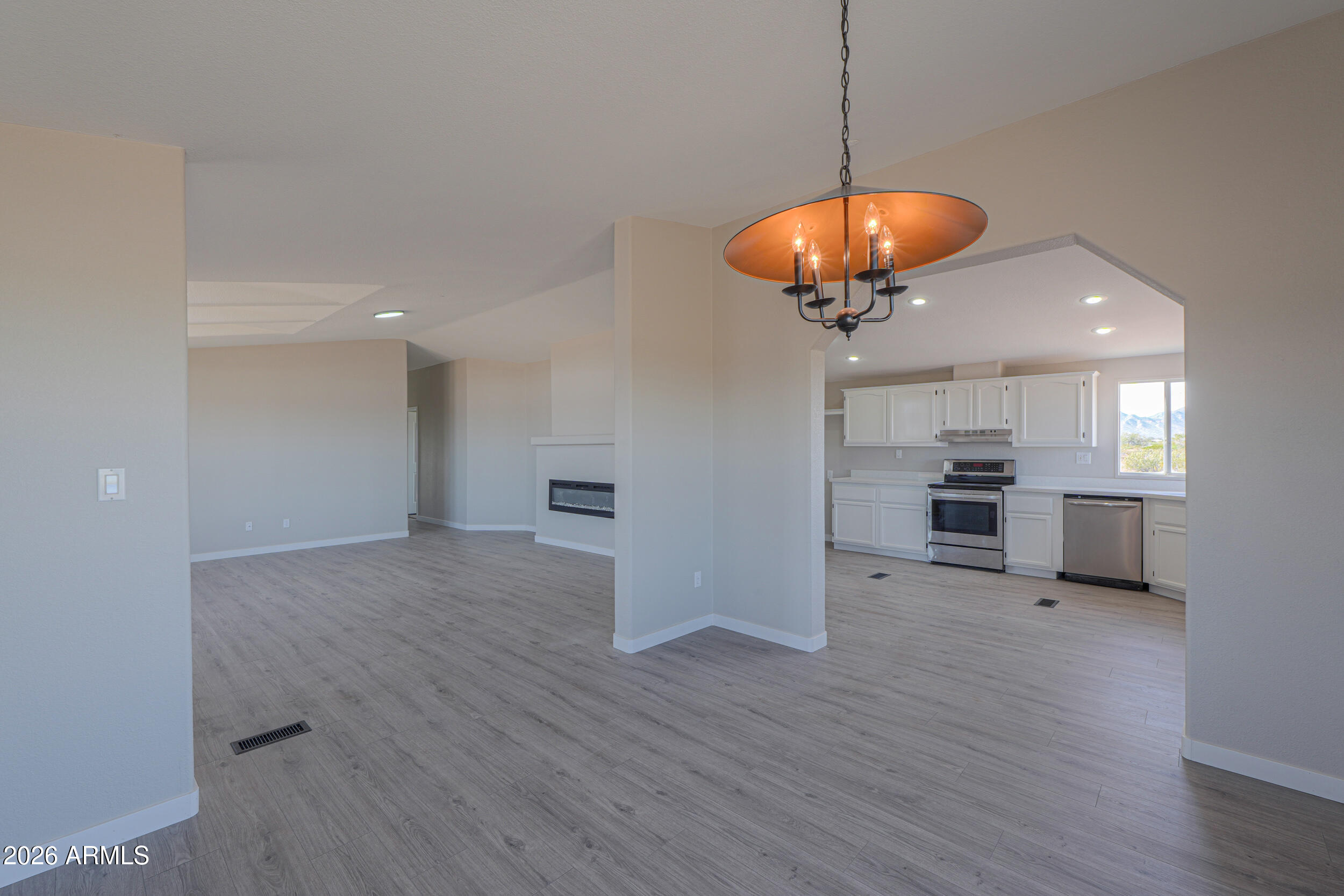 161 North Pueblo Road Maricopa, AZ 85139 - Photo 15 of 76 a view of a room with wooden floor and a ceiling fan