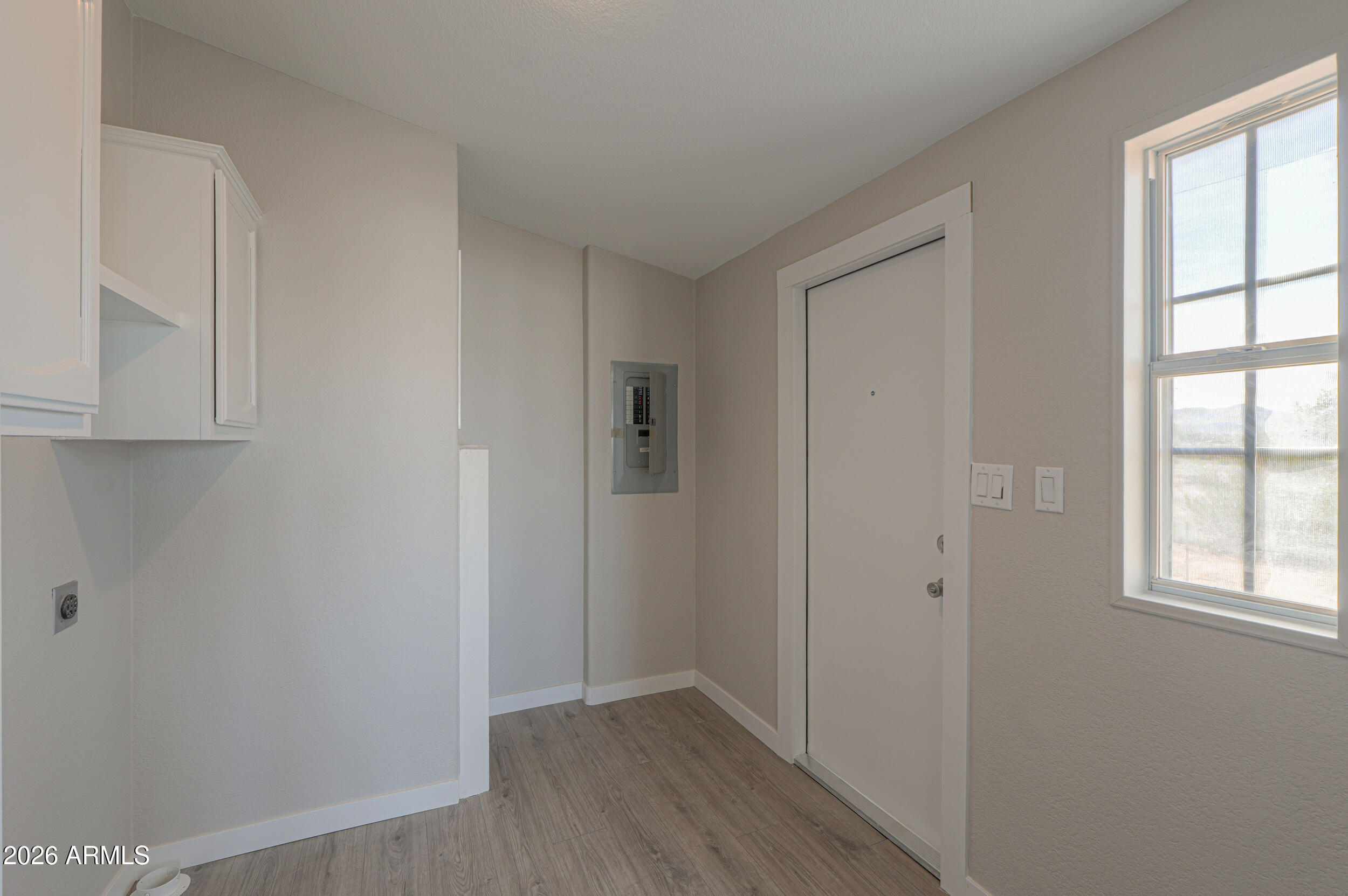 161 North Pueblo Road Maricopa, AZ 85139 - Photo 27 of 76 a view of an empty room with wooden floor and entryway
