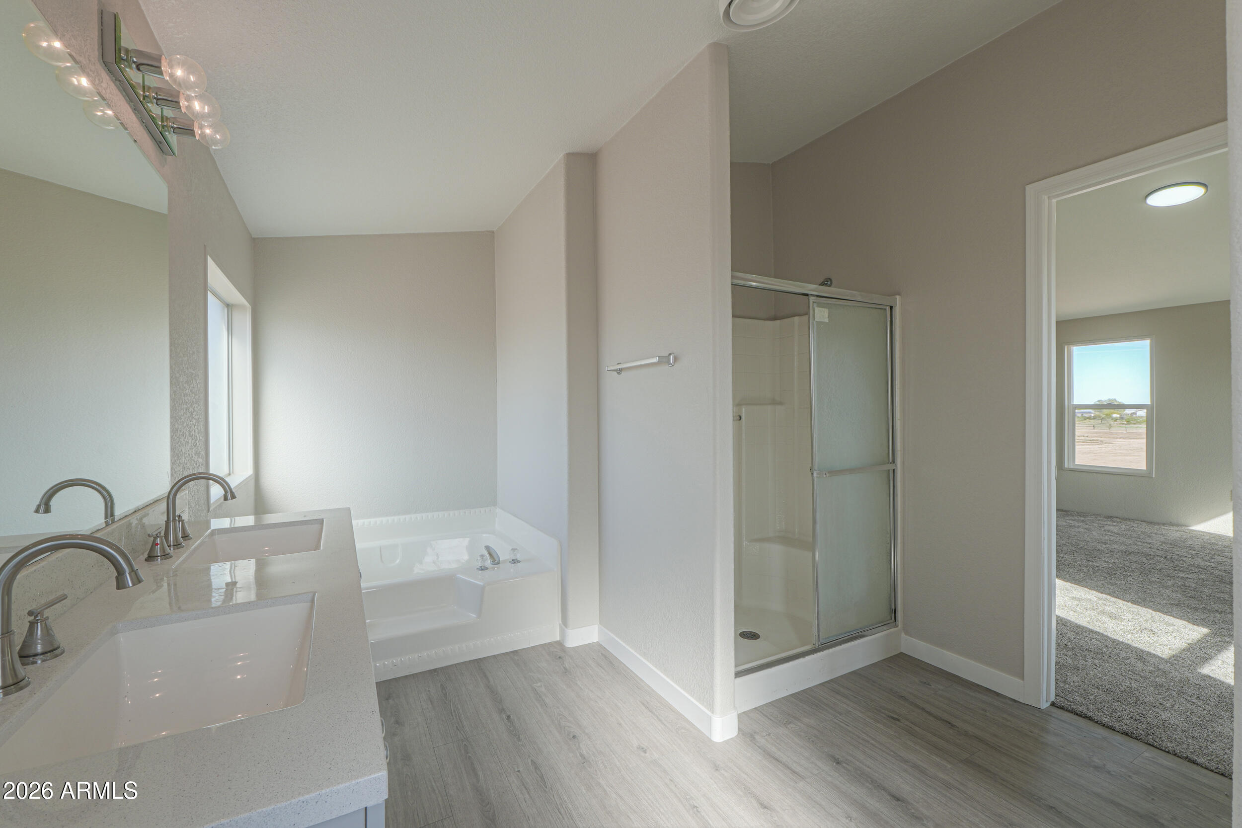 161 North Pueblo Road Maricopa, AZ 85139 - Photo 45 of 76 a bathroom with a bathtub and a sink