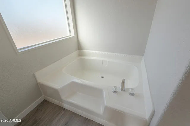 a front view of a house with a yard and mountain view in back