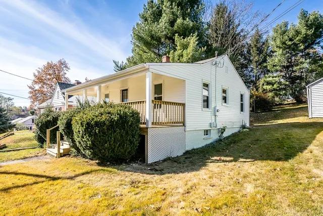 a view of a white house with a yard
