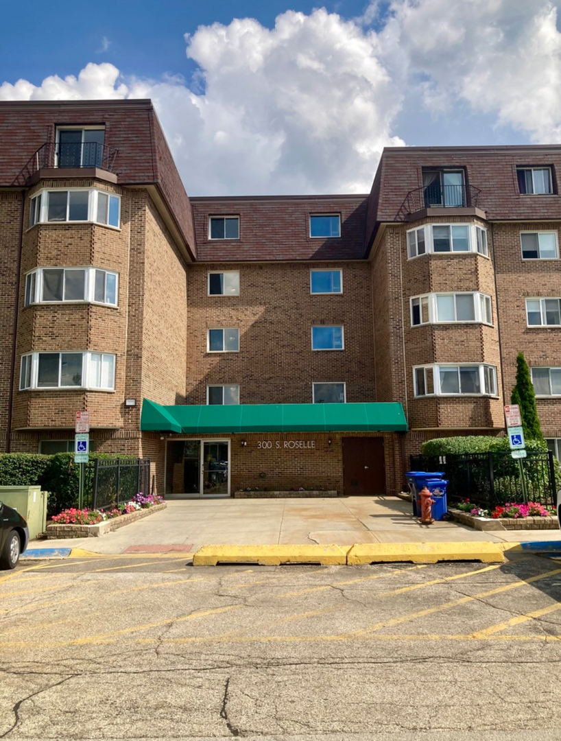 300 South Roselle Road, Unit 207 Schaumburg, IL 60193 - Photo 1 of 17 a front view of a building with a swimming pool