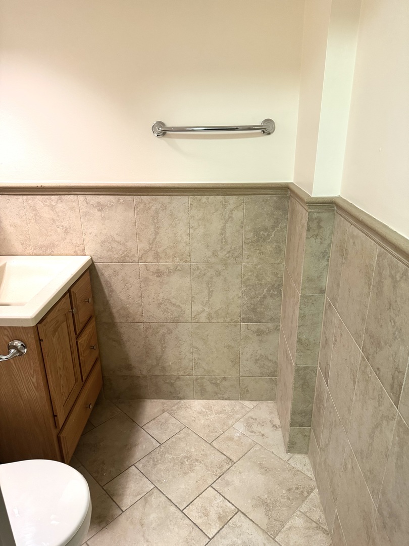 300 South Roselle Road, Unit 207 Schaumburg, IL 60193 - Photo 12 of 17 a bathroom with a toilet and a shower