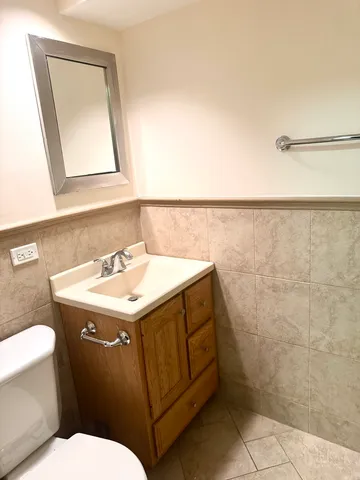 a bathroom with a sink a toilet and mirror