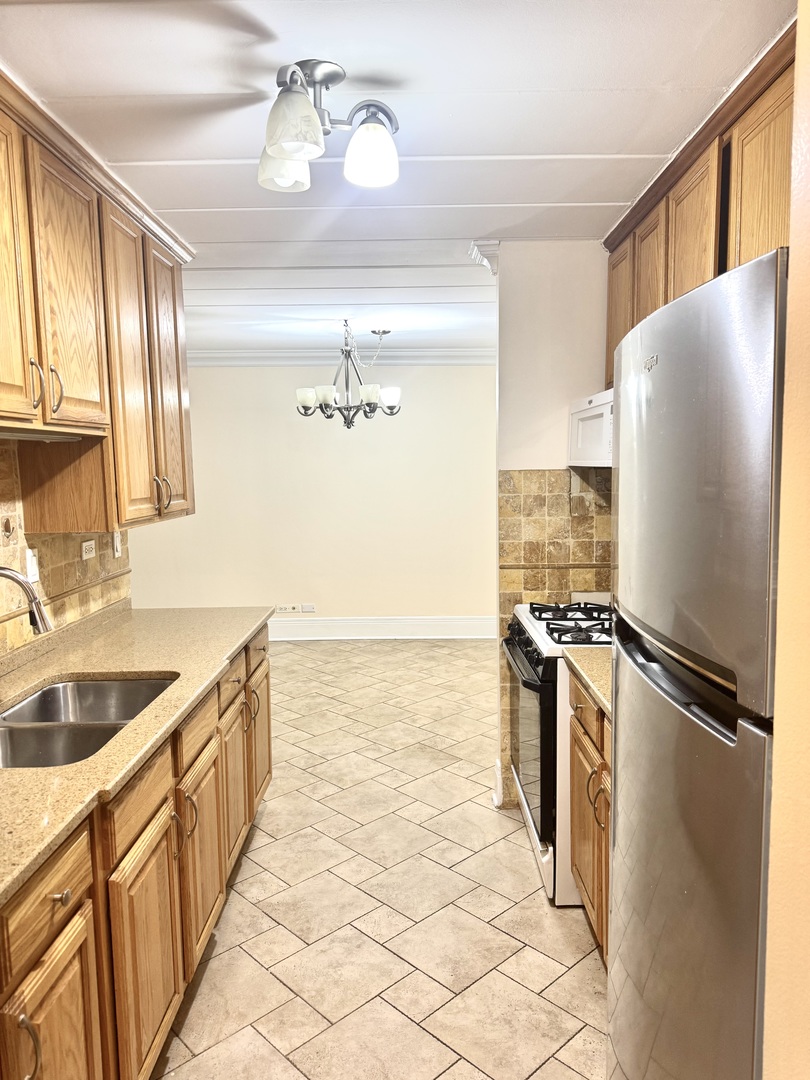 300 South Roselle Road, Unit 207 Schaumburg, IL 60193 - Photo 5 of 17 a kitchen with stainless steel appliances granite countertop a refrigerator and a sink