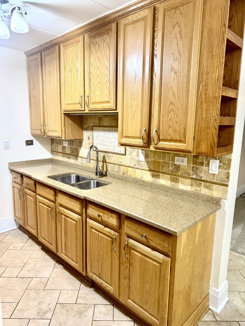 300 South Roselle Road, Unit 207 Schaumburg, IL 60193 - Photo 6 of 17 a kitchen with stainless steel appliances granite countertop a sink and a white cabinets