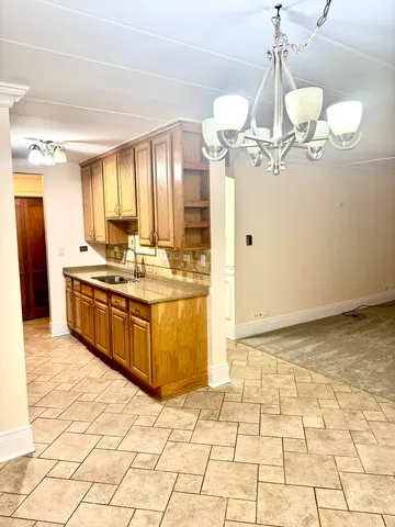 a kitchen with stainless steel appliances a sink a counter top space cabinets and a counter top space