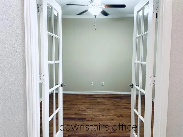 a view of a room with wooden floor and windows