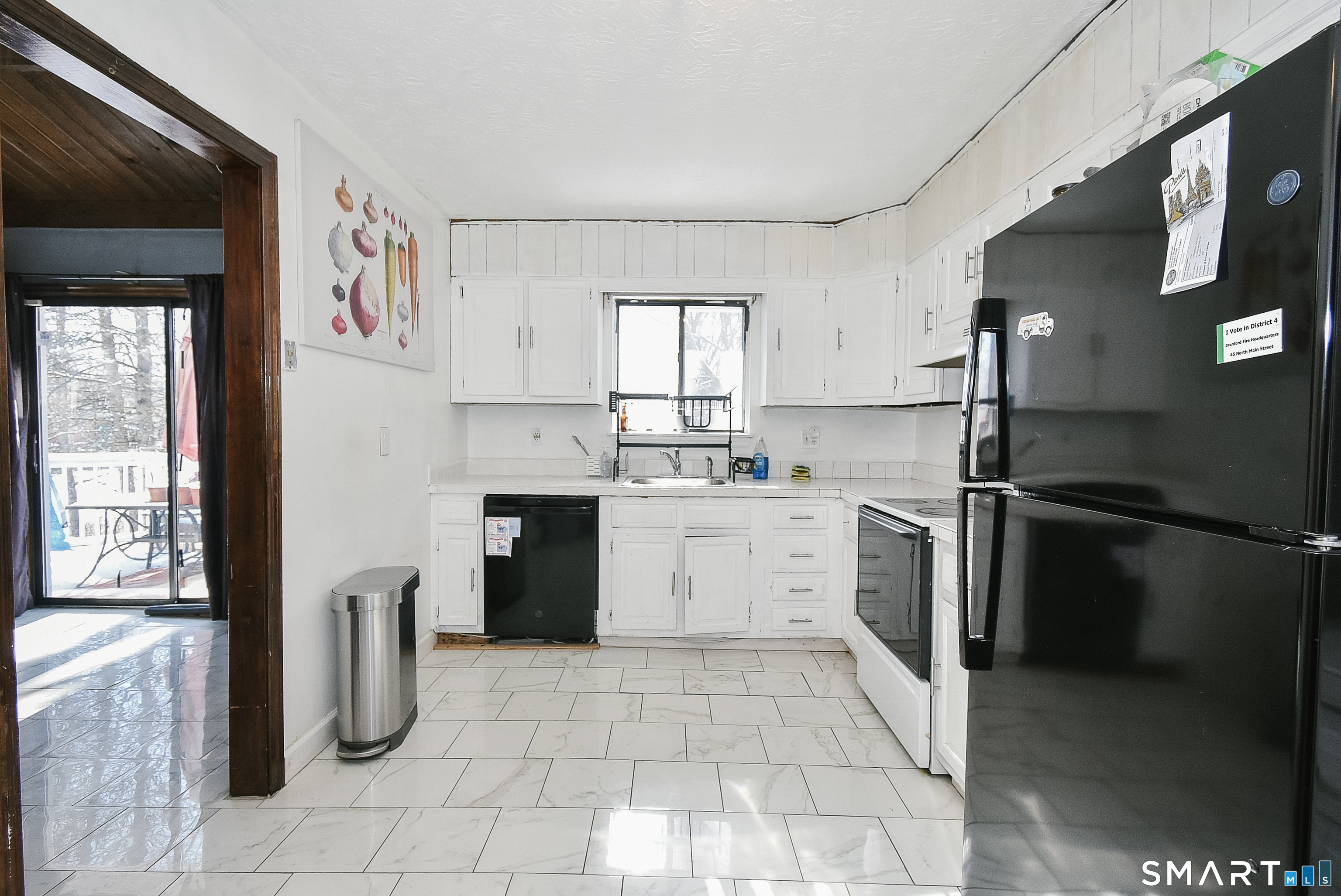 63 Millbrook Road Middletown, CT 06457 - Photo 11 of 29 a kitchen with a sink a refrigerator and cabinets