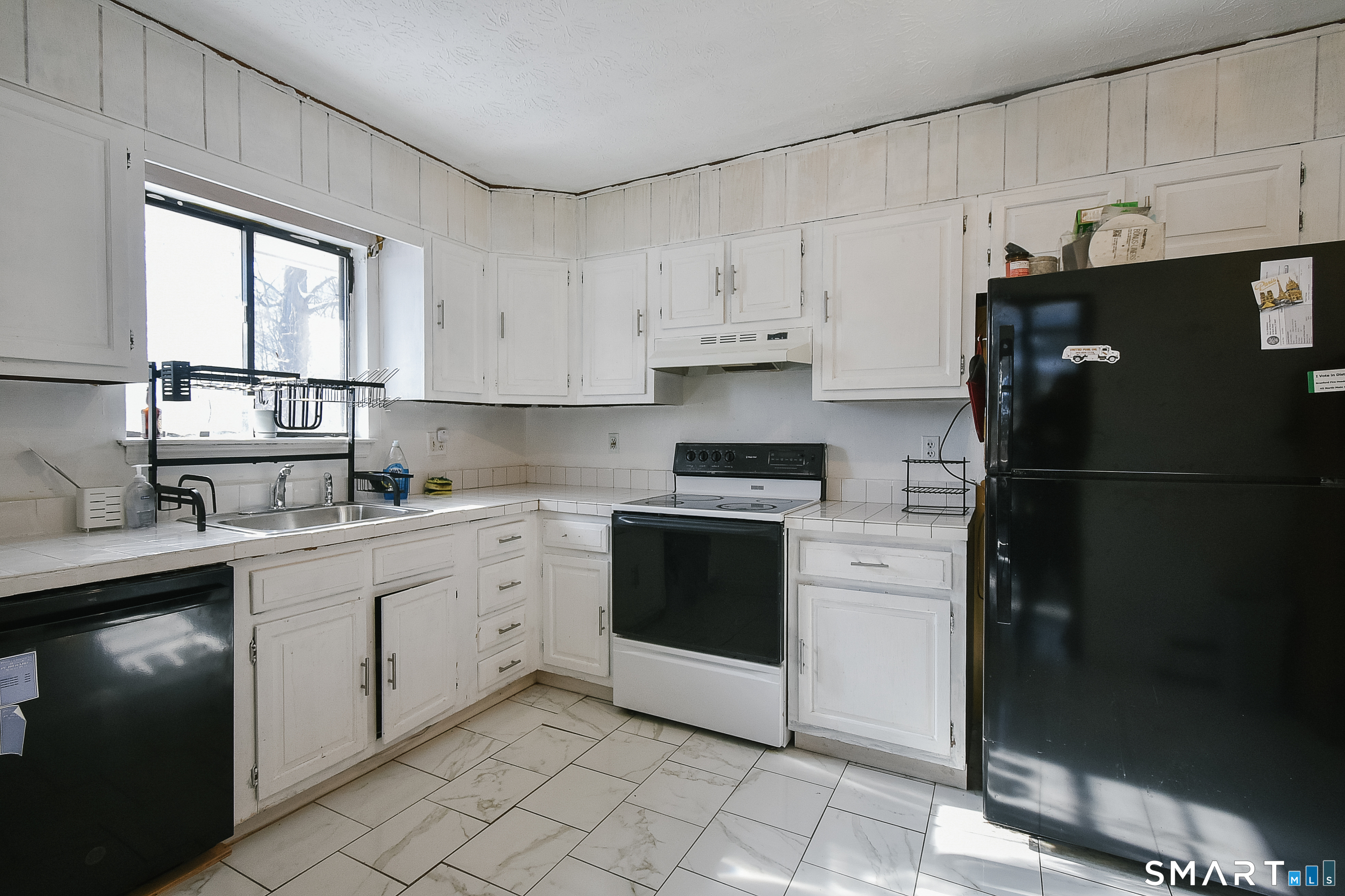 63 Millbrook Road Middletown, CT 06457 - Photo 15 of 29 a kitchen with a refrigerator sink and cabinets