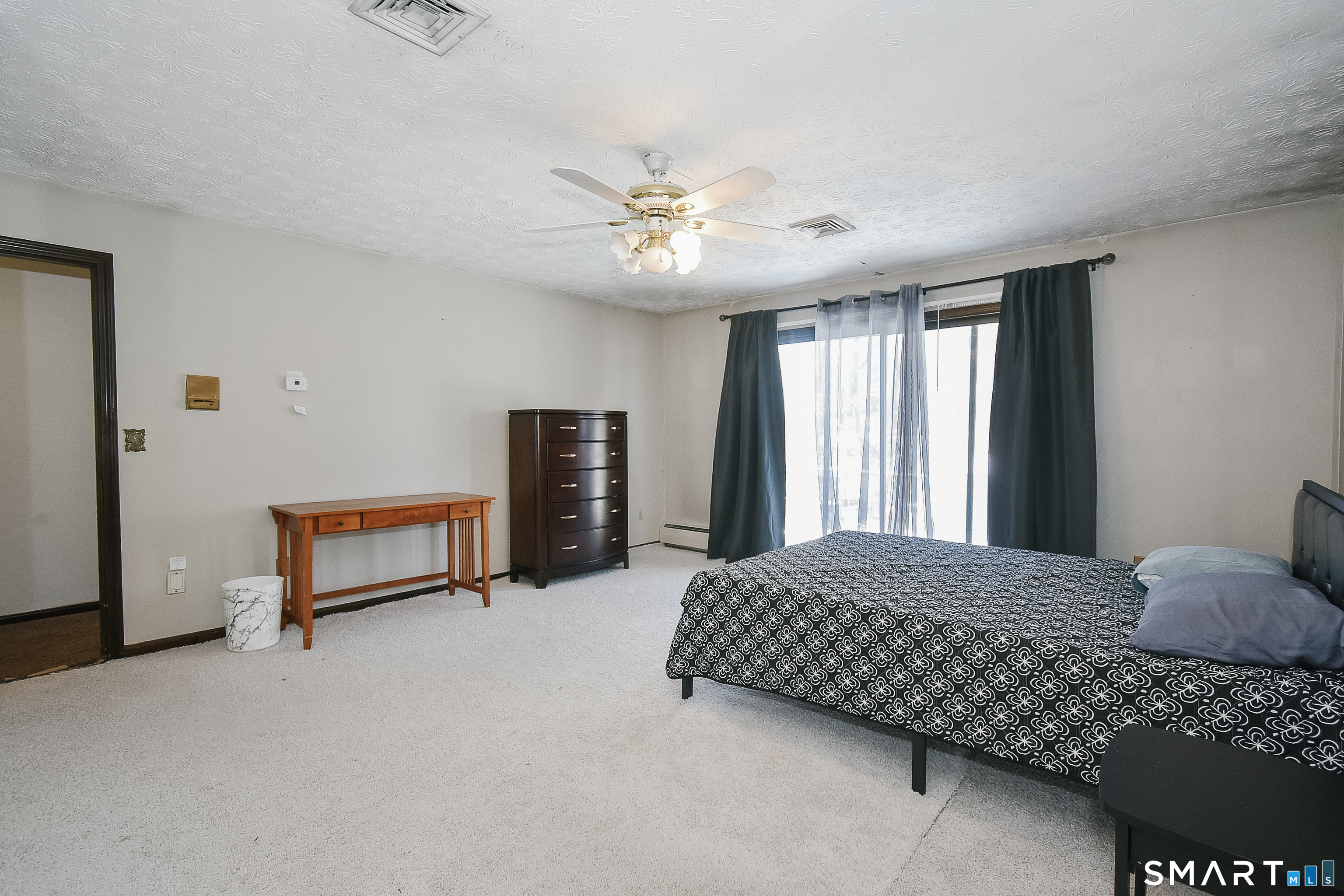 63 Millbrook Road Middletown, CT 06457 - Photo 19 of 29 a bedroom with a bed and a ceiling fan