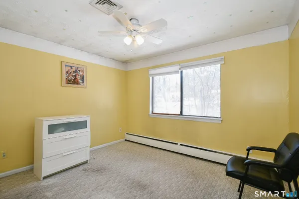 a view of room with window and ceiling fan