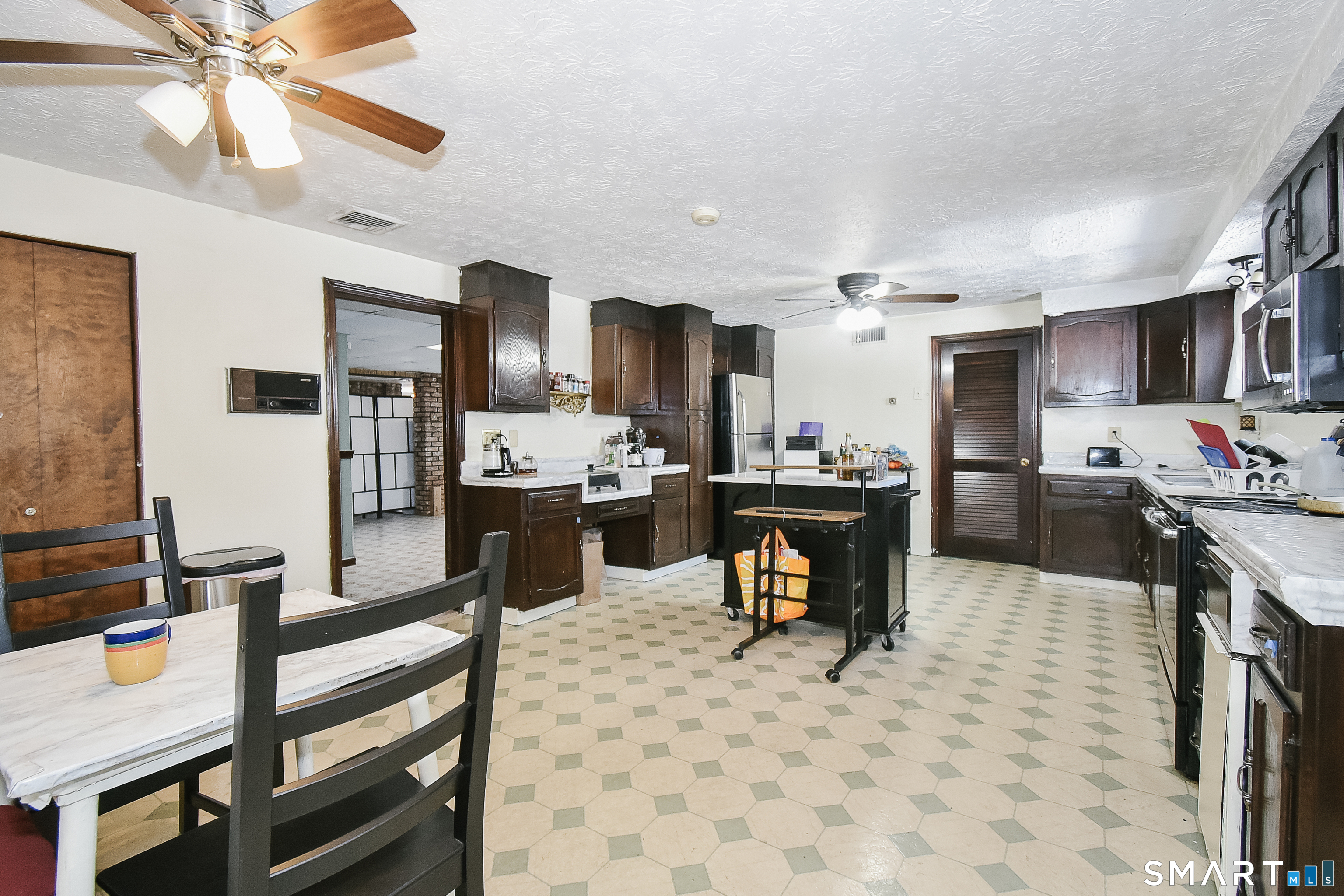 63 Millbrook Road Middletown, CT 06457 - Photo 26 of 29 a kitchen with stainless steel appliances kitchen island granite countertop a table chairs microwave and sink
