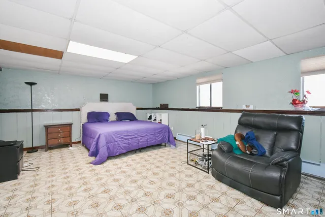 a bedroom with a bed and a potted plant