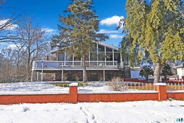 a view of swimming pool with a yard and large tree