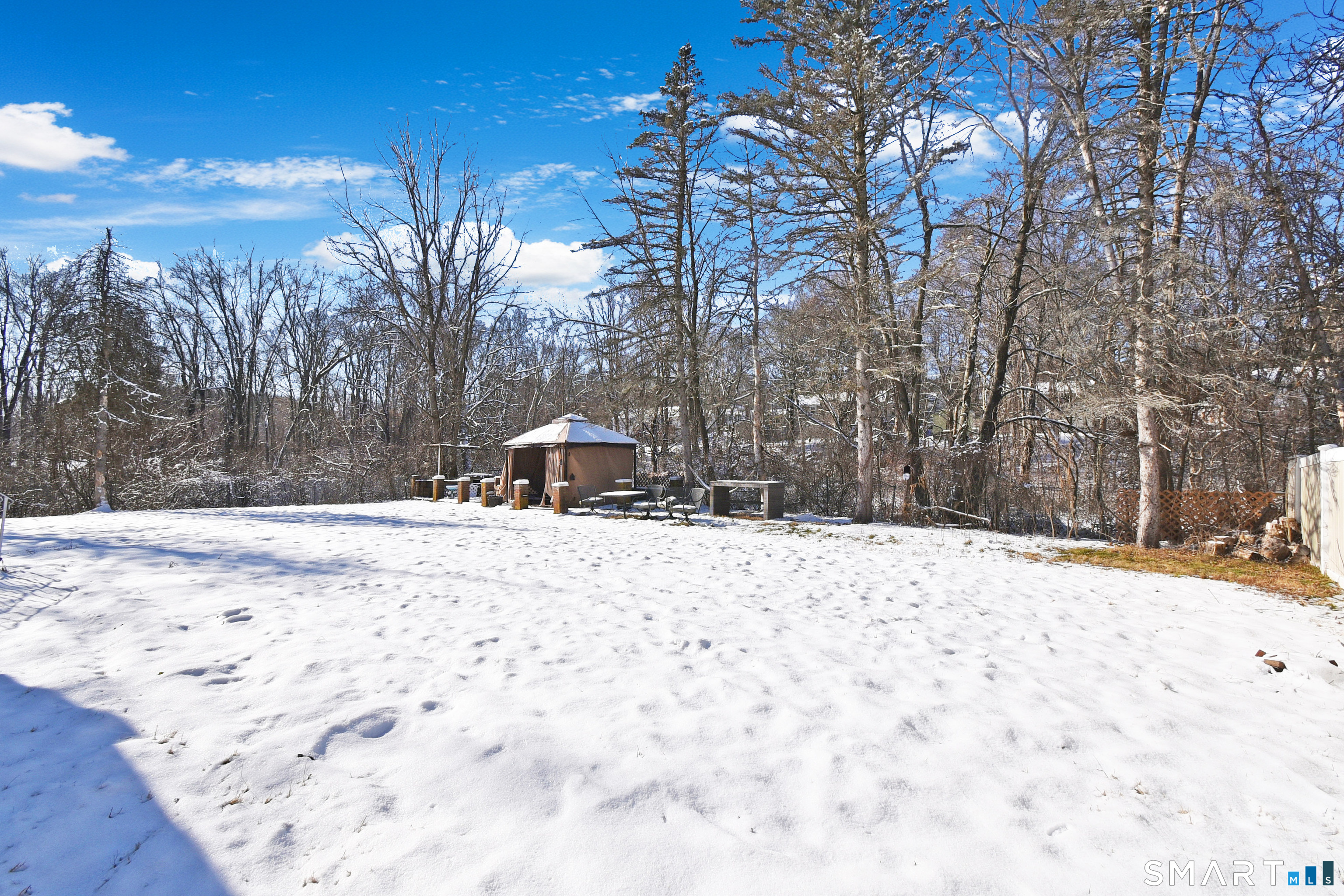 63 Millbrook Road Middletown, CT 06457 - Photo 4 of 29 a wooden bench sitting in middle of a snow