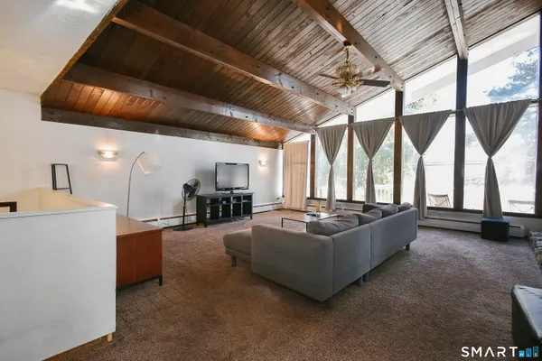 a living room with furniture and a large window