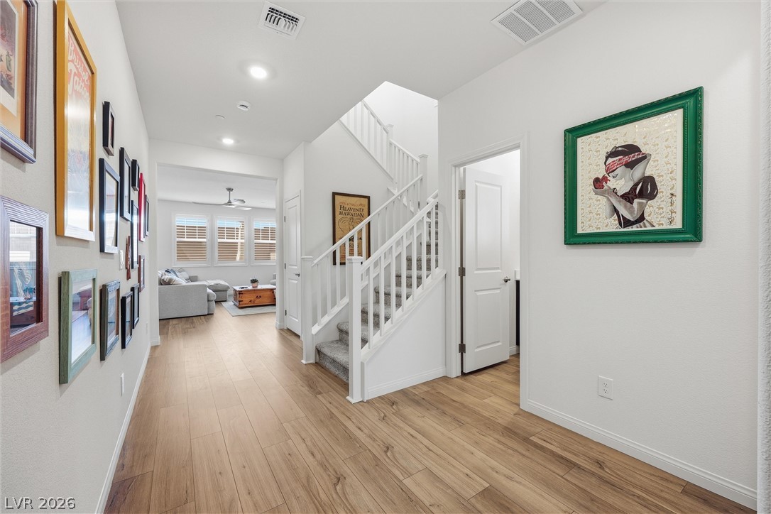 3705 Alla Rocca Avenue Henderson, NV 89044 - Photo 4 of 50 This inviting hallway features sleek hardwood floors leading to a bright, open living area.