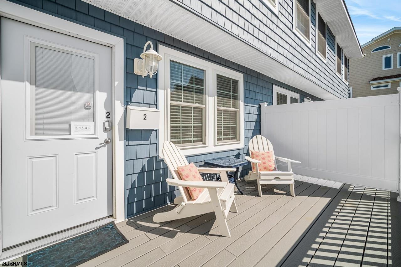 229 10th Street North, Unit 2 Brigantine, NJ 08203 - Photo 1 of 27 a view of a patio with a table and chairs and wooden floor