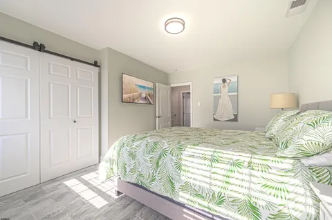 a bed sitting in a bedroom next to a cabinet