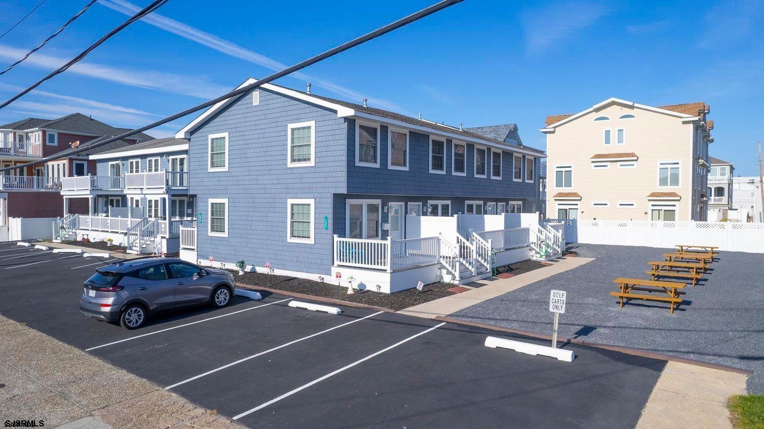 229 10th Street North, Unit 2 Brigantine, NJ 08203 - Photo 14 of 27 a front view of a building with parking area