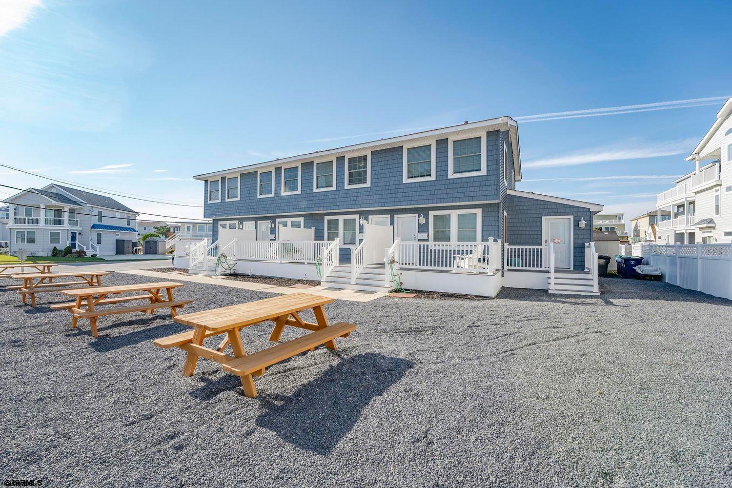 229 10th Street North, Unit 2 Brigantine, NJ 08203 - Photo 18 of 27 a swimming pool with outdoor seating and yard