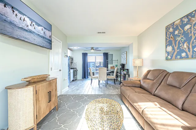a living room with furniture and a open to kitchen