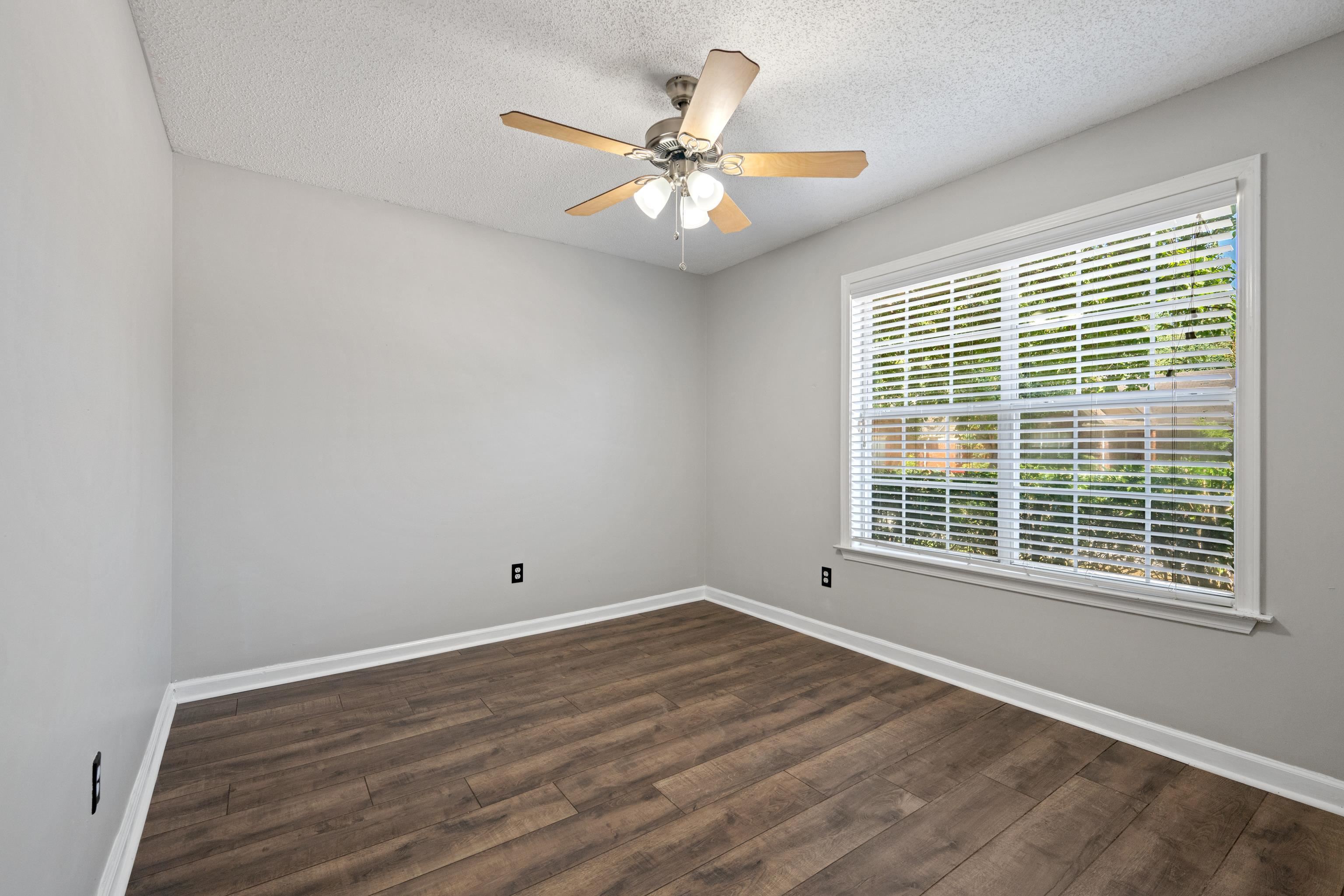 1361 Milestone Circle Collierville, TN 38017 - Photo 19 of 23 a view of an empty room with wooden floor and a window