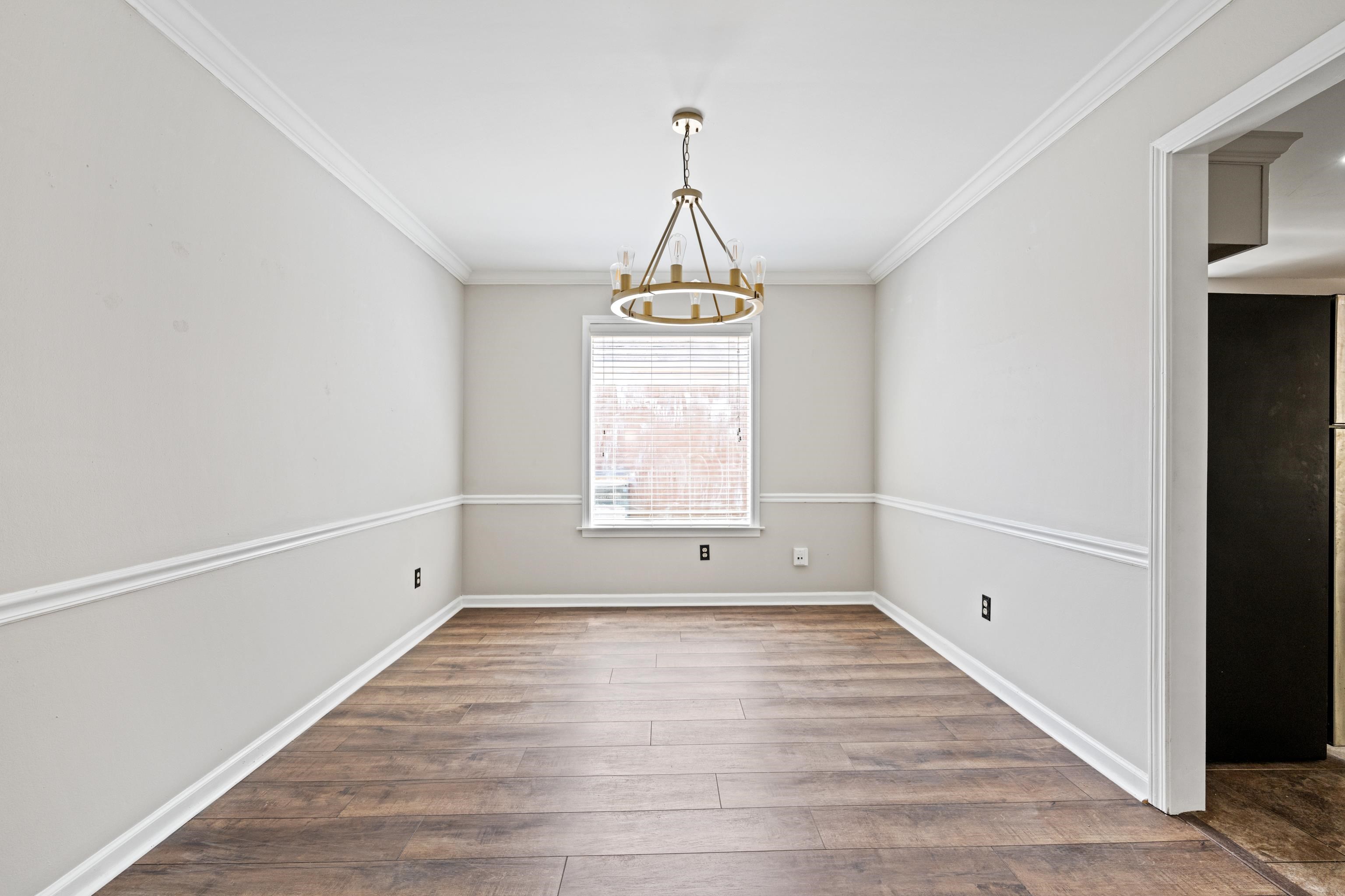 1361 Milestone Circle Collierville, TN 38017 - Photo 7 of 23 a view of an empty room with wooden floor and a window