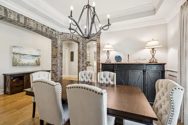 a kitchen with stainless steel appliances a dining table chairs microwave and sink