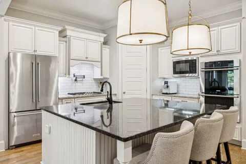 a kitchen with stainless steel appliances granite countertop a stove a sink and a granite counter tops