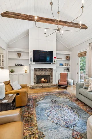 a spacious bedroom with a bed a couch and a chandelier