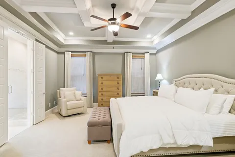 a en suite bathroom with a granite countertop sink mirror and shower