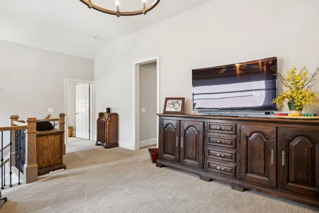 a living room with furniture a chandelier and a large window