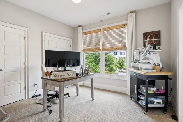 a roof deck with couches and potted plants
