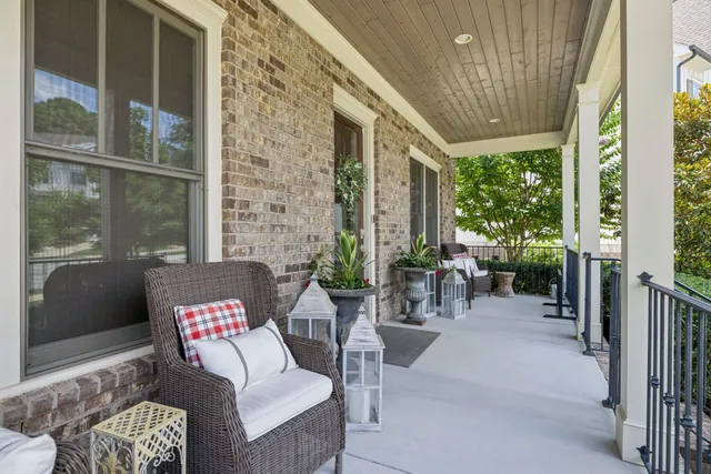 an empty room with wooden floor cabinet and windows