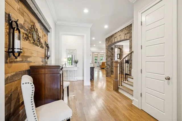 a dining room with furniture a chandelier and wooden floor
