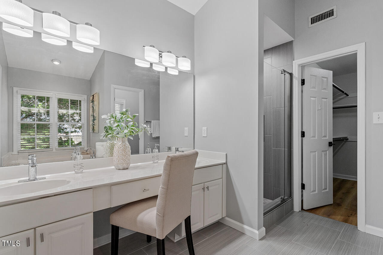 9004 Admaston Drive Raleigh, NC 27613 - Photo 21 of 30 The bathroom features a double sink vanity, a separate toilet area, shower and a tub.