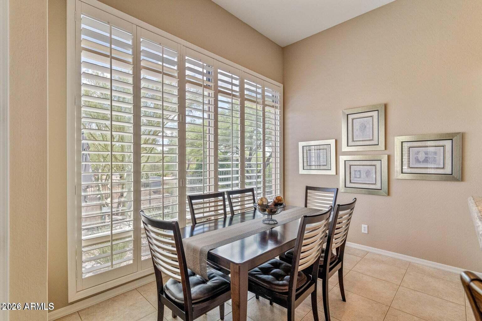 26601 North Aguila Road Rio Verde, AZ 85263 - Photo 11 of 45 a view of a dining room with furniture and wooden floor