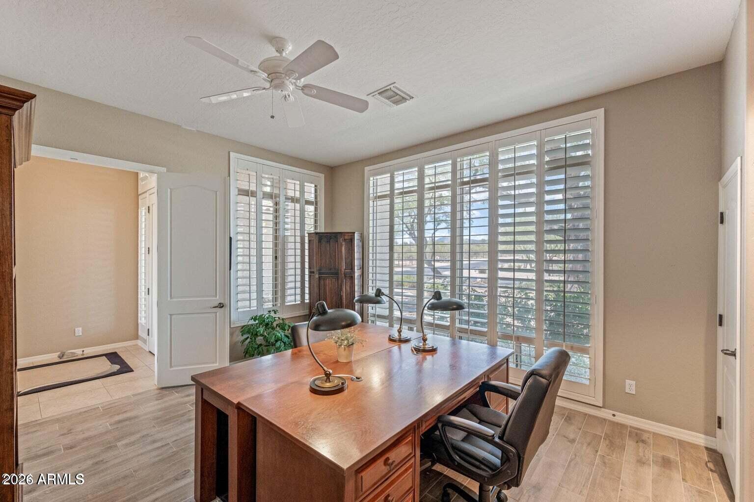 26601 North Aguila Road Rio Verde, AZ 85263 - Photo 15 of 45 a view of a dining room with furniture window and wooden floor