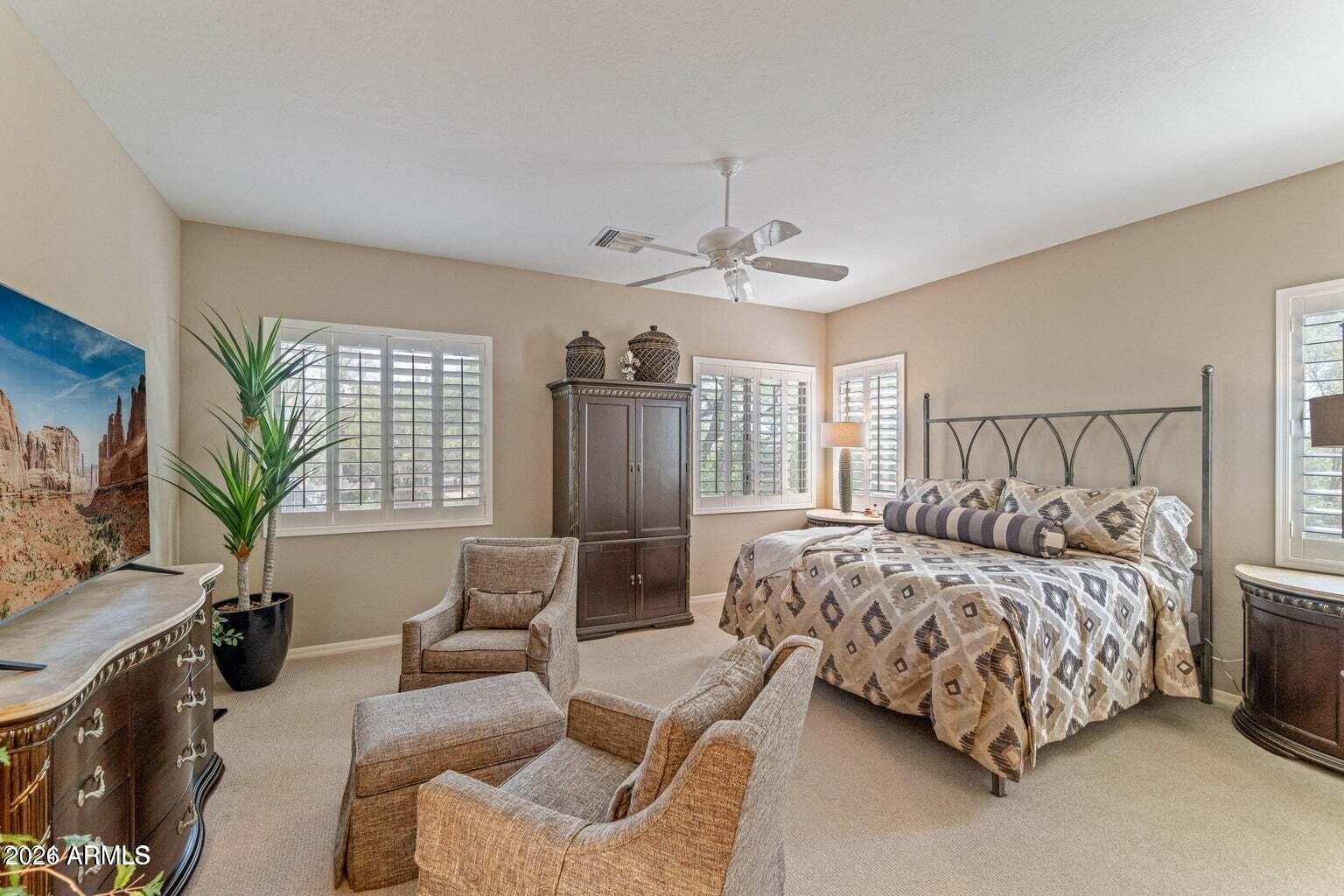 26601 North Aguila Road Rio Verde, AZ 85263 - Photo 17 of 45 a bedroom with a bed couch and windows