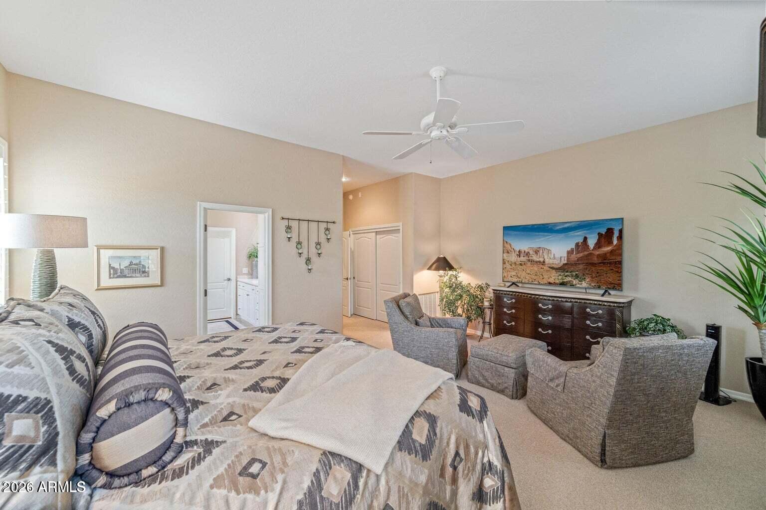 26601 North Aguila Road Rio Verde, AZ 85263 - Photo 18 of 45 a bedroom with bed and a couch