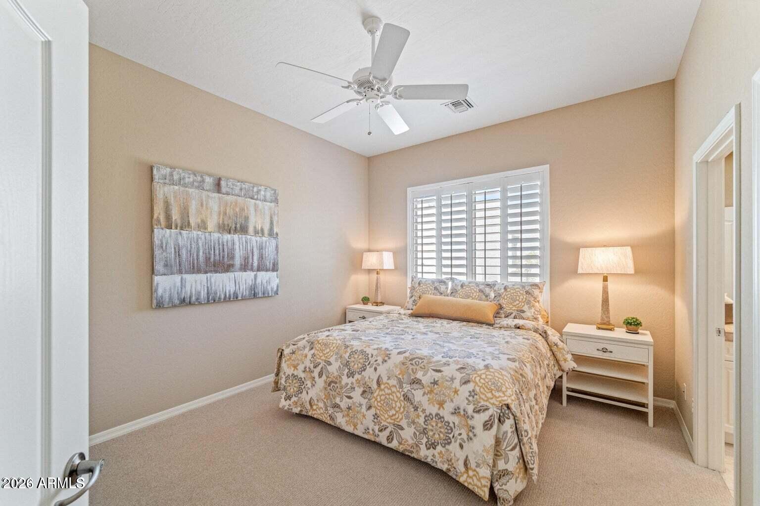 26601 North Aguila Road Rio Verde, AZ 85263 - Photo 25 of 45 a bedroom with a bed and a painting on the wall