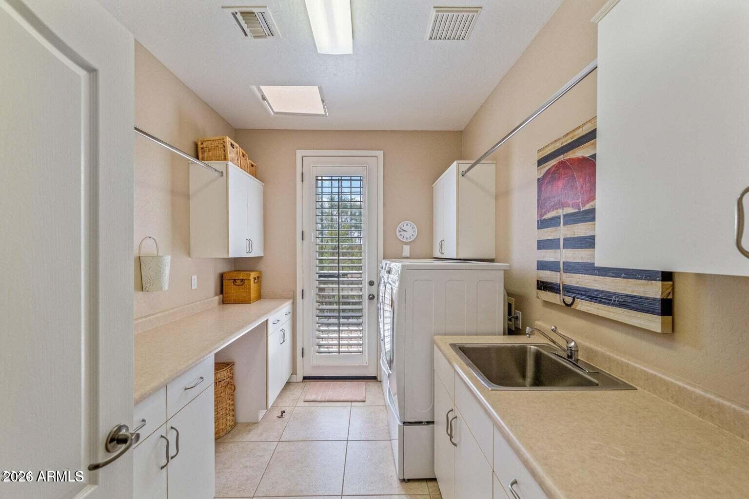 26601 North Aguila Road Rio Verde, AZ 85263 - Photo 31 of 45 a kitchen with stainless steel appliances a sink stove and cabinets