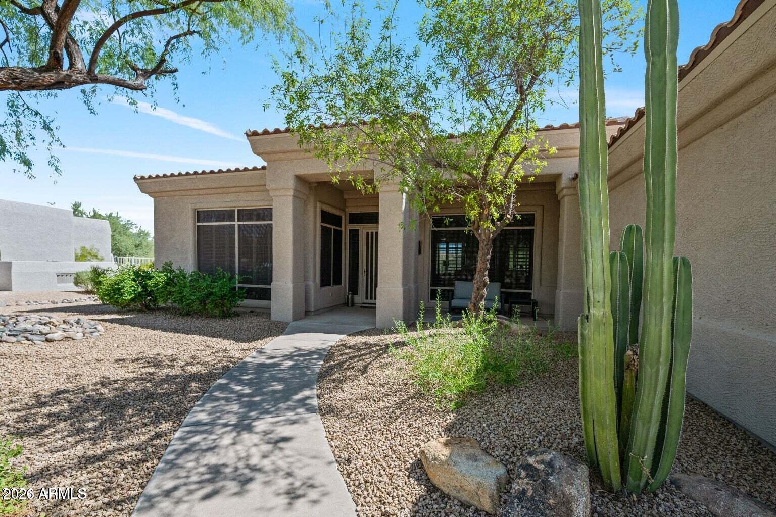 26601 North Aguila Road Rio Verde, AZ 85263 - Photo 37 of 45 a front view of a house with a porch